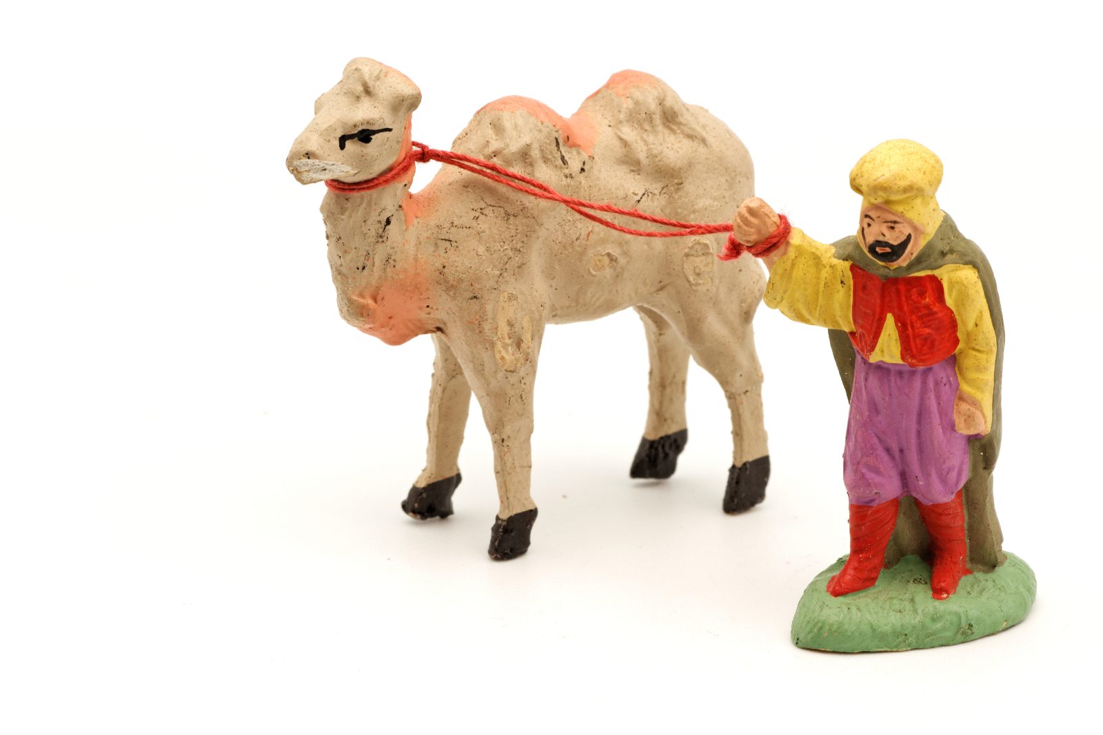Santon of a camel driver with his dromedary, a single piece on a neutral background for a collector