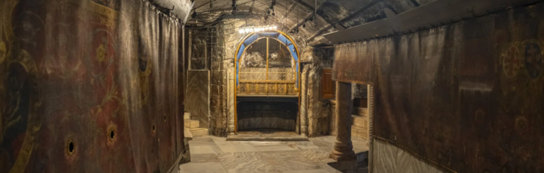 View of the grotto of the Nativity before restoration: the altar, the hangings and the hanging lamps.